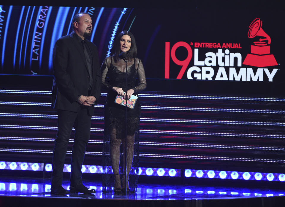 Pepe Aguilar, left, and Laura Pausini present the award for record of the year at the Latin Grammy Awards on Thursday, Nov. 15, 2018, at the MGM Grand Garden Arena in Las Vegas. (Photo by Chris Pizzello/Invision/AP)