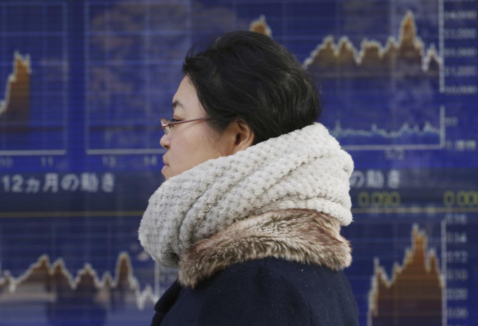 A woman walks by an electronic stock board of a securities firm in Tokyo, Monday, Nov. 26, 2018. Asian shares were mostly higher Monday on hopes that U.S. President Donald Trump and his Chinese counterpart Xi Jinping will unwind a blistering trade dispute at a meeting this week.(AP Photo/Koji Sasahara)