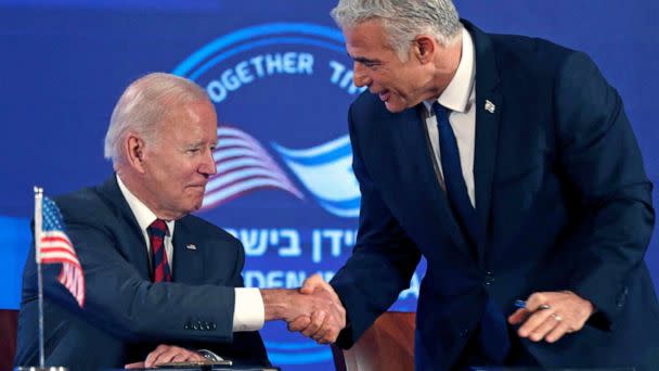 PHOTO: President Joe Biden and Israel's caretaker Prime Minister Yair Lapid, shake hands before signing a security pledge in Jerusalem, on July 14, 2022.  (Atef Safadi/POOL/AFP via Getty Images)