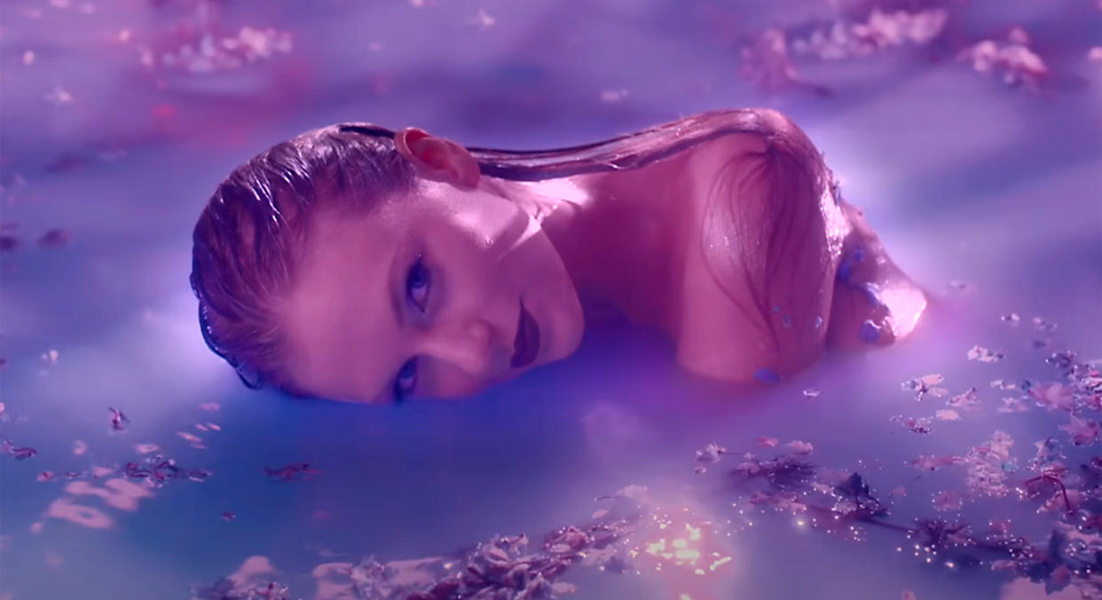 A blissful-looking Swift floats in a lavender pool.  (Vevo)