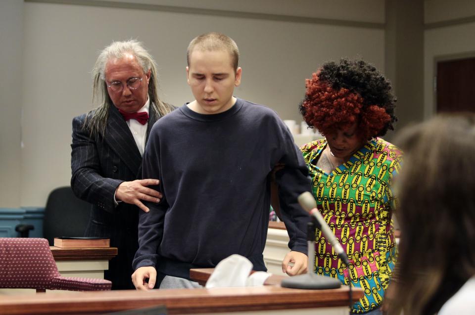 Victor Razumov, center, is led to the witness stand by his attorney Harley Breite and an unidentified woman as he is called to testify during his competency hearing in state Superior Court on July 18, 2018, in Newton. Razumov is accused of slitting the throat of Wantage resident Virginia "Suzy" Sommer during a 2012 burglary in her home.