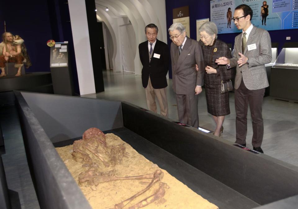 FILE - In this Wednesday, Jan. 18, 2017 file photo, Japan's Emperor Akihito, second left, and Empress Michiko, second right, look at a replica of fossils of a Cro‐Magnon man while listening to museum employee Yosuke Kaifu, right, during their visit to an exhibition "Lascaux: The Cave Painting of the Ice Age" at the National Museum of Nature and Science in Tokyo. A Japanese government panel studying a possible abdication of the emperor is set to release Monday, Jan. 23, an interim report that supports enacting special legislation that is applicable only to him. At left is the museum's Director General Yoshihiro Hayashi. (AP Photo/Shizuo Kambayashi, File)