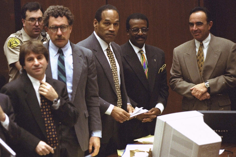 FILE - Defendant O.J. Simpson and members of his defense team react as the jury, many wearing white T-shirts sporting a slogan from a local pizza chain, walk into the courtroom in Los Angeles Friday, May 5, 1995. From left to right are" Barry Scheck, Peter Neufeld, O.J. Simpson, Johnnie Cochran Jr., and Robert Shapiro. Background is Deputy Guy Magnera. Simpson, the decorated football superstar and Hollywood actor who was acquitted of charges he killed his former wife and her friend but later found liable in a separate civil trial, has died. He was 76. (AP Photo/Reed Saxon, Pool, File)