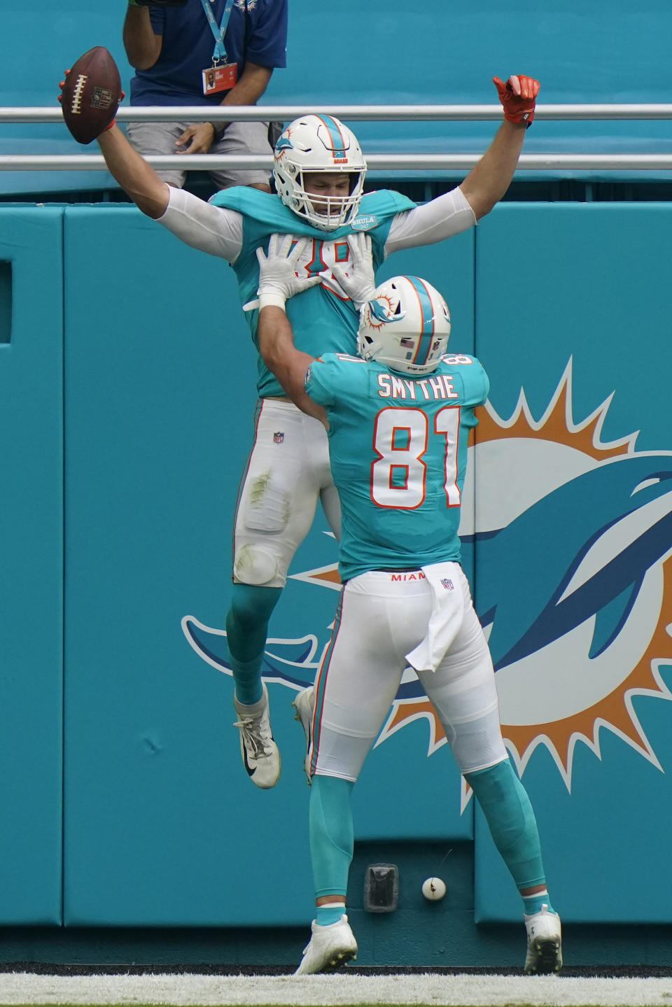 Miami Dolphins tight end Durham Smythe (81) lifts tight end Mike Gesicki (88) after Gesicki scored a touchdown, during the second half of an NFL football game against the Cincinnati Bengals, Sunday, Dec. 6, 2020, in Miami Gardens, Fla. (AP Photo/Lynne Sladky)