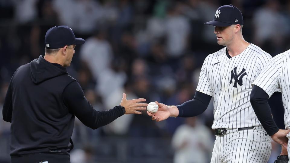 May 20, 2024; Bronx, New York, USA; New York Yankees relief pitcher Clay Holmes (35) hands the ball to manager Aaron Boone (17) after being taken out of the game against the Seattle Mariners during the ninth inning at Yankee Stadium.