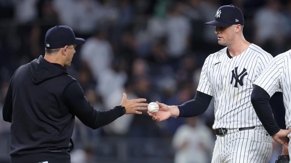 May 20, 2024;  Bronx, New York, USA;  New York Yankees relief pitcher Clay Holmes (35) hands the ball to manager Aaron Boone (17) after being removed from the game against the Seattle Mariners during the ninth inning at Yankee Stadium.