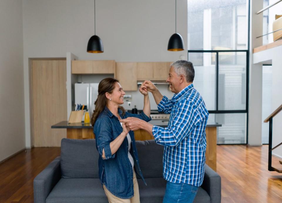 romantic adult couple dancing at home