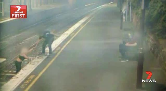 One of the PSOs notices the woman on the train tracks and rushes to her aid. Picture: 7 News