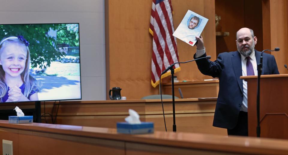 02-21-24: Manchester, NH: The trial of Adam Montgomery (not pictured) who is charged with murdering his five year old daughter Harmony continued today inside Courtroom 1 at the Hillsborough County Superior Court. Pictured is Senior Assistant New Hampshire Attorney General Benjamin Agati (right) as during closing arguments he shows the jury a photograph of the defendant, who he told them murdered his daughter, whose photo is on the screen at left.   (Jim Davis for the Boston Globe).