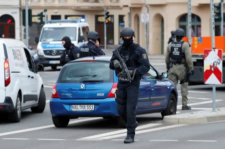 Police officers guard near the site of a shooting in Halle