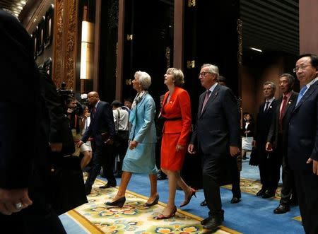 Britain's Prime Minister Theresa May (C), International Monetary Fund (IMF) Managing Director Christine Legarde (centre L) and European Commission President Jean-Claude Juncker (centre R) arrive at the opening of the G20 Summit in Hangzhou, Zhejiang province, China, September 4, 2016. REUTERS/Aly Song