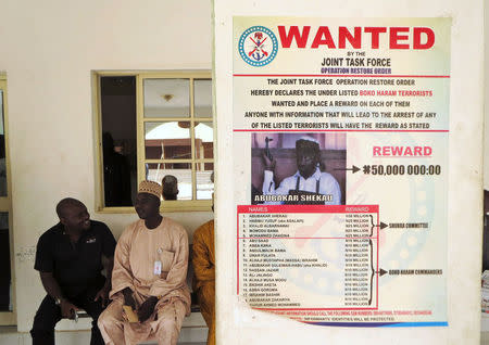 A poster advertising the search for Boko Haram leader Abubakar Shekau and other fighters is pasted on a wall in Baga village on the outskirts of Maiduguri, in the northeastern state of Borno in this May 13, 2013 file photo. REUTERS/Tim Cocks/Files