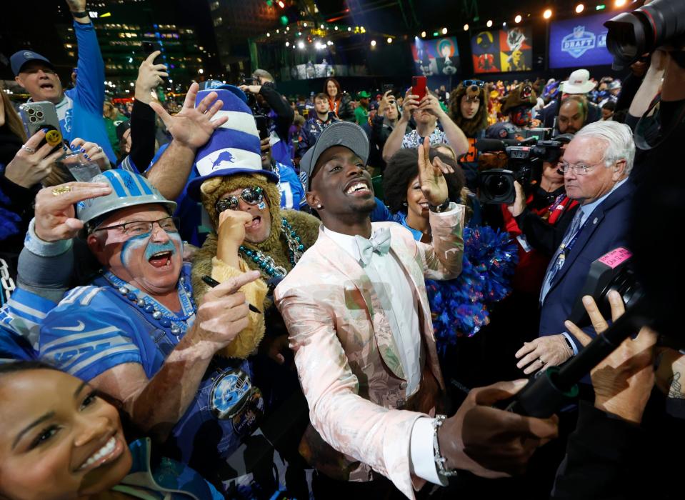 Terrion Arnold, a cornerback from Alabama, celebrates with Detroit Lions fans after he was picked in the first round of the 2024 NFL draft at the NFL draft theater in Detroit on Thursday, April 25, 2024. At left is diehard Lions fan Ron "Crackman" Crachiola.