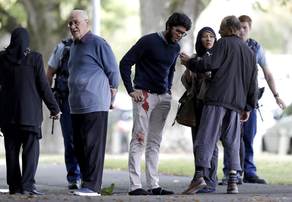 People stand across the road from the mosque in central Christchurch after the attack on Friday, March 15. Source: AP