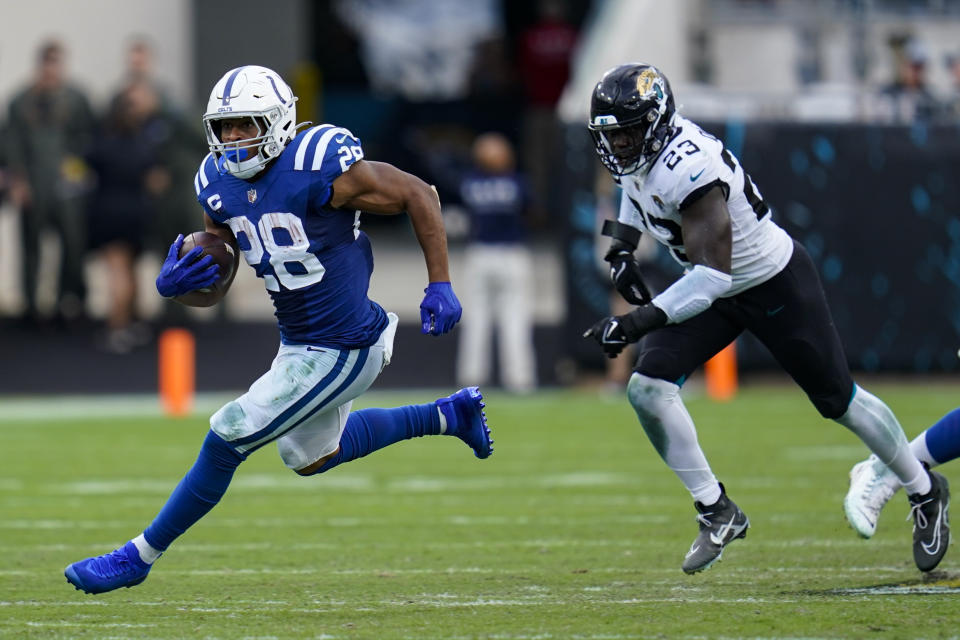 Indianapolis Colts running back Jonathan Taylor (28) get past Jacksonville Jaguars linebacker Foyesade Oluokun (23) for a gain during the second half of an NFL football game, Sunday, Sept. 18, 2022, in Jacksonville, Fla. (AP Photo/John Raoux)