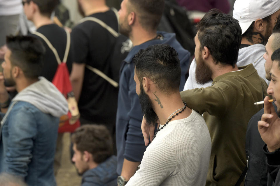 Young men attend a demonstration in Chemnitz, Germany, Monday, Aug. 27, 2018 after a man has died and two others were injured in an altercation between several people of "various nationalities" in the eastern German city of Chemnitz on Sunday. (AP Photo/Jens Meyer)