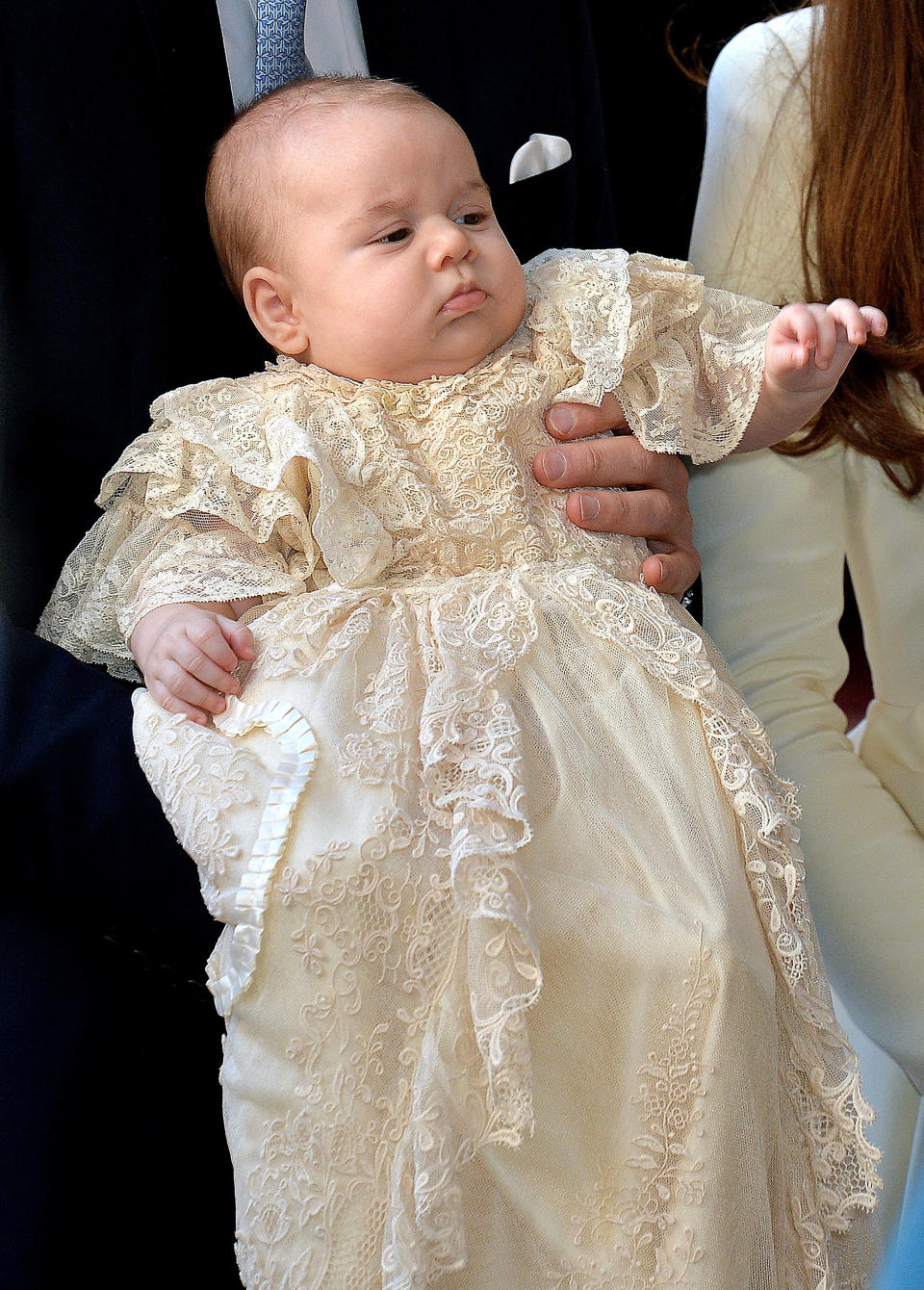 Prince George wearing the Honiton lace and white satin gown at his christening in October 2013. [Photo: Getty]