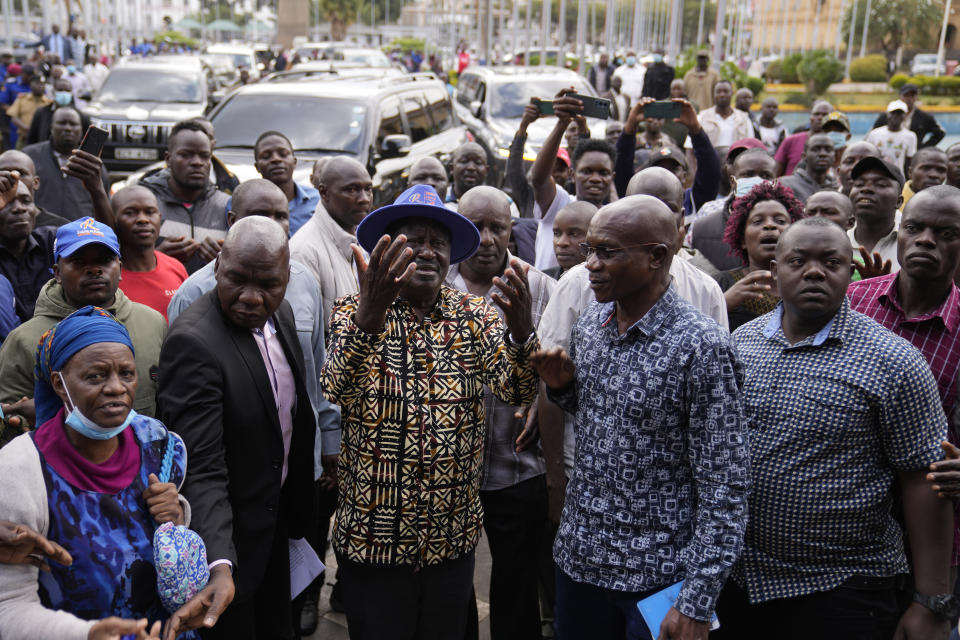 Kenyan presidential candidate Raila Odinga, center, speaks with the crowd prior to delivering an address to the nation at his campaign headquarters in downtown Nairobi, Kenya, Tuesday, Aug. 16, 2022. Kenya is calm a day after Deputy President William Ruto was declared the winner of the narrow presidential election over longtime opposition figure Raila Odinga. (AP Photo/Ben Curtis)