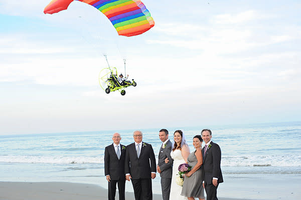 <div class="caption-credit">Photo by: Neil GT Photography</div><div class="caption-title">Bombs Away!</div><p> Wait, how do we land this thing again? Way to one-up the bride, thumbs-up rainbow parachute guy. </p> <p> <i>Have a photobomb of your own that you'd like to share? Upload your pic to</i> <i><span>BG's Facebook page</span> or</i><i><span>submit it to us via Instagram</span> (be sure to include the hashtag #bgphotobombs) and we may add it to our list!</i> </p>