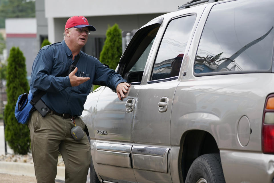 Coleman Boyd, a Mississippi physician an ardent anti-abortion advocate, left, speaks to a driver waiting for a passenger outside the Jackson Women's Health Organization clinic, Thursday, May 20, 2021, in Jackson, Miss. The clinic is Mississippi's only state licensed abortion facility. On May 17, 2021, the U.S. Supreme Court agreed to take up the dispute over a Mississippi ban on abortions after 15 weeks of pregnancy. The issue is the first test of limits on abortion access to go before the conservative majority high court. Their decision could mean more restrictions, and focuses on the landmark 1973 ruling in Roe v. Wade, which established a woman's right to an abortion. (AP Photo/Rogelio V. Solis)