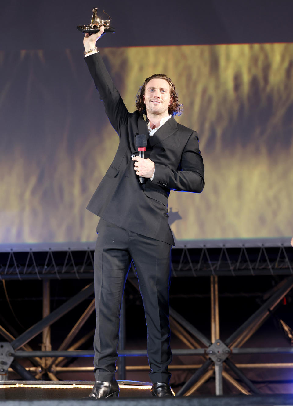 <p>Aaron Taylor-Johnson speaks on stage during the Davide Campari Excellence Award Winner ceremony at the 2022 Locarno Film Festival in Switzerland on Aug. 3.</p>