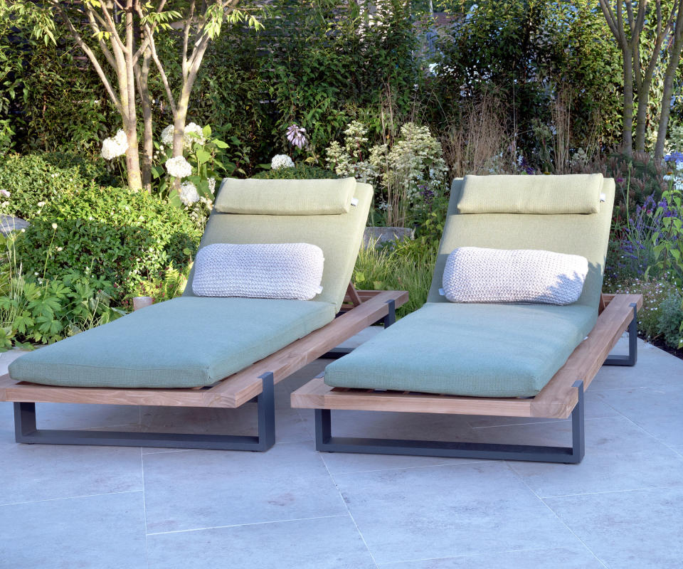 two sun loungers on a paved patio