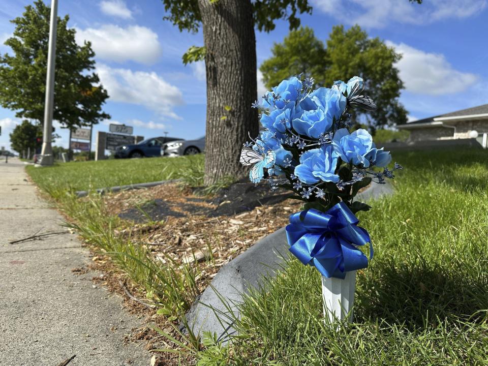 Flowers rest near the scene, Saturday, July 15, 2023, in Fargo, N.D., where one police officer was fatally shot and two others were critically wounded Friday, July 14. Authorities have said the suspect was also killed in the shooting, and a civilian was injured. (AP Photo/Jack Dura).