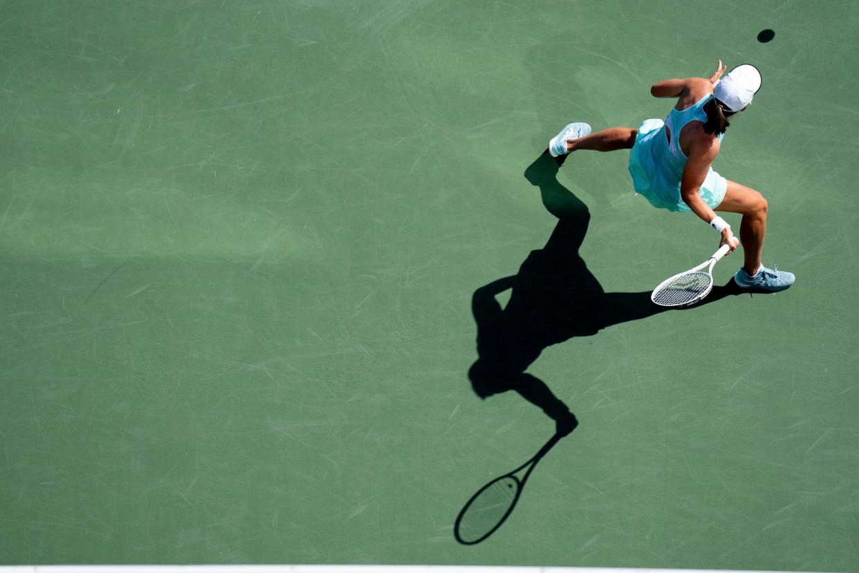 Iga Swiatek hits a return to Sloane Stephens during their match in the Western & Southern Open at the Lindner Family Tennis Center in Mason, Ohio, on Wednesday, Aug. 17, 2022. Fritz defeated Kyrgios 6-3, 6-2.