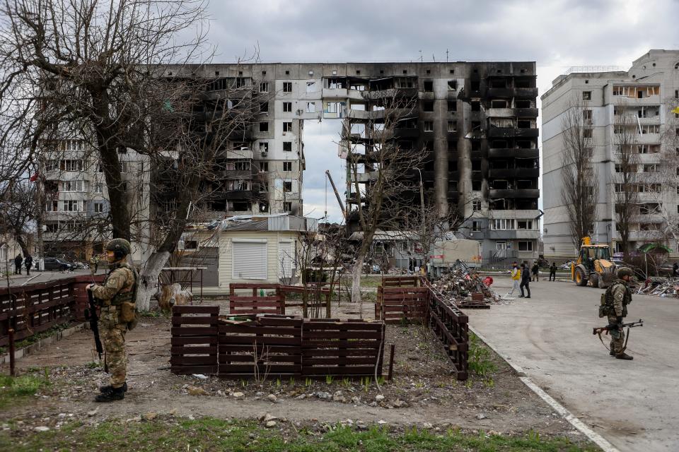 Officer guard a building destroyed by Russian shelling, amid Russia's Invasion of Ukraine, in Borodyanka, Kyiv region, Ukraine, April 11, 2022.