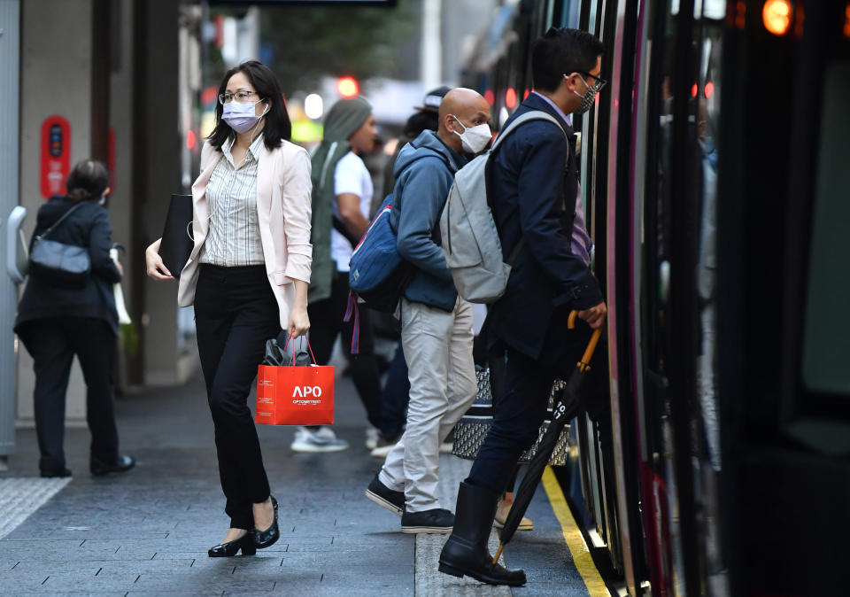 Passengers wearing face masks use a light rail service in Sydney on Thursday. Source: AAP