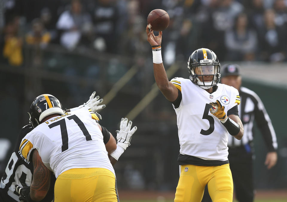 Pittsburgh Steelers quarterback Joshua Dobbs (5) passes against the Oakland Raiders during the second half of an NFL football game in Oakland, Calif., Sunday, Dec. 9, 2018. (AP Photo/Ben Margot)