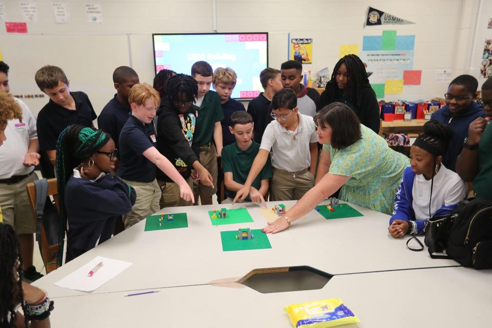 Raegan Dillon, the 2024 SCCPSS Teacher of the Year, talks with students about a LEGO project during the first day of school on Thursday, August 3, 2023 at The Stem Academy.