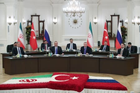 Turkish President Tayyip Erdogan speaks during a meeting with his counterparts Putin of Russia and Rouhani of Iran in Ankara