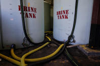 Hoes used to fill brine are seen near brine tank storage bins ahead of a winter storm at the GDOT's Maintenance Activities Unit location on Friday, Jan. 14, 2022, in Forest Park, Ga. A winter storm is headed south that could effect much of Georgia through Sunday. (AP Photo/Brynn Anderson)