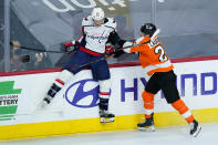 Philadelphia Flyers' Scott Laughton (21) collides with Washington Capitals' Nic Dowd (26) during the third period of an NHL hockey game, Sunday, March 7, 2021, in Philadelphia. (AP Photo/Matt Slocum)