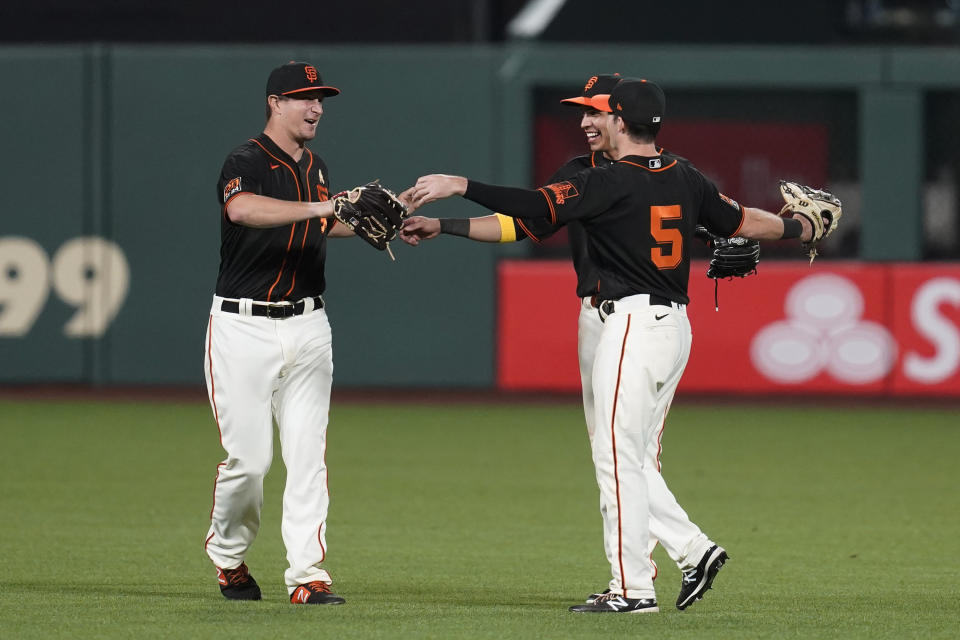 San Francisco Giants outfielders, from left, Alex Dickerson, Mauricio Dubon and Mike Yastrzemski celebrate at the end of a baseball game against the Arizona Diamondbacks on Saturday, Sept. 5, 2020, in San Francisco. San Francisco won 4-3. (AP Photo/Eric Risberg)