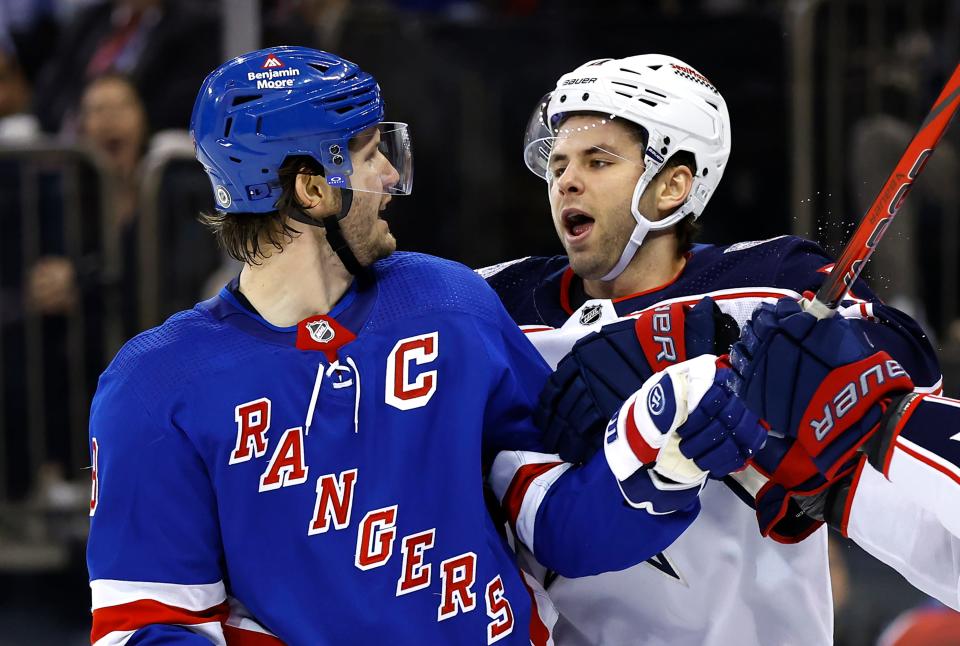 Columbus Blue Jackets center Adam Fantilli (11) talks to New York Rangers defenseman Jacob Trouba (8) after a scuffle during the first period of an NHL hockey game, Sunday, Nov. 12, 2023, in New York. (AP Photo/Noah K. Murray)