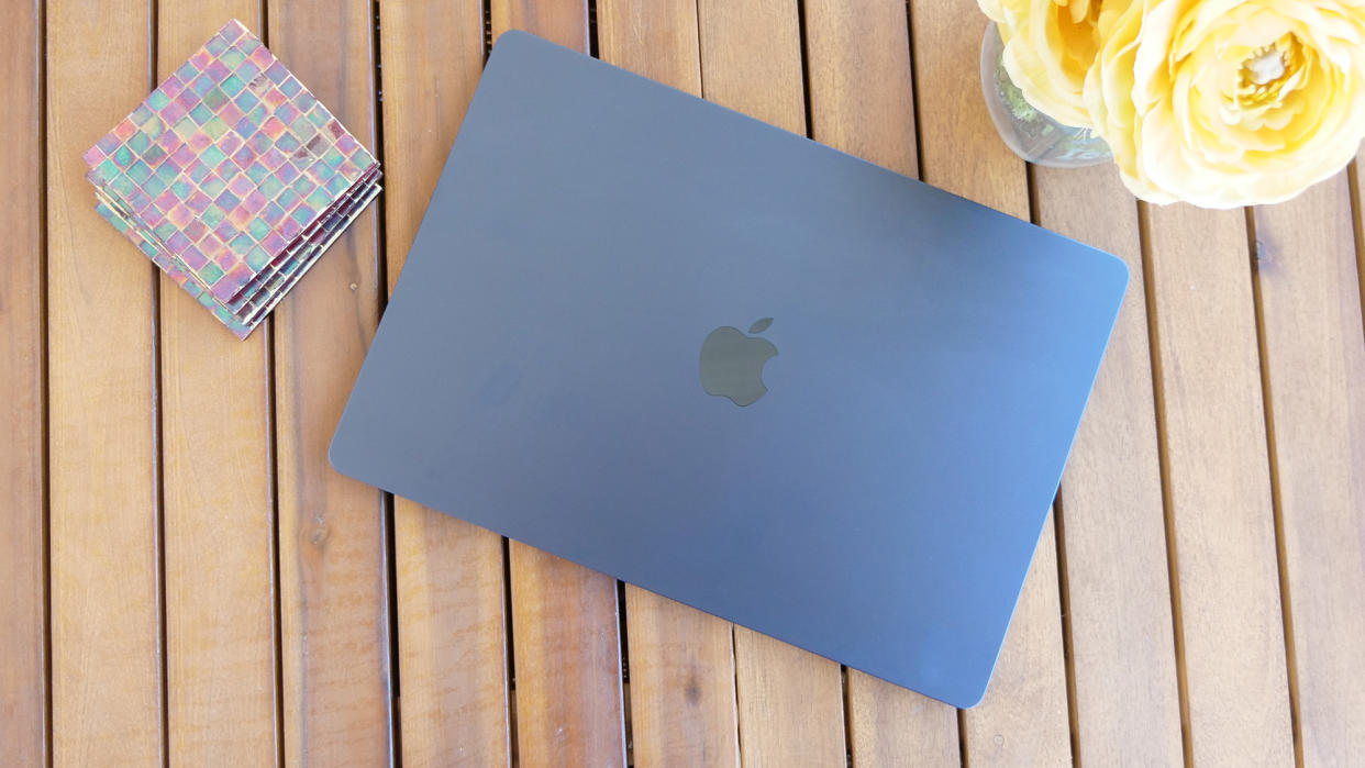  MacBook Air 15 M3 lid closed on a slatted wooden table. 