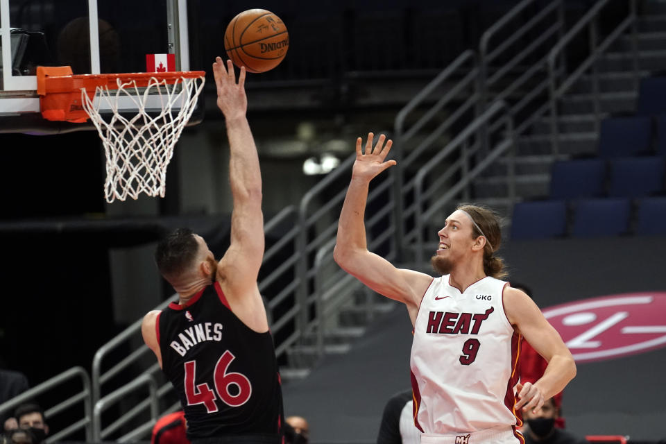 Toronto Raptors center Aron Baynes (46) goes up to block a shot by Miami Heat forward Kelly Olynyk (9) during the second half of an NBA basketball game Friday, Jan. 22, 2021, in Tampa, Fla. (AP Photo/Chris O'Meara)