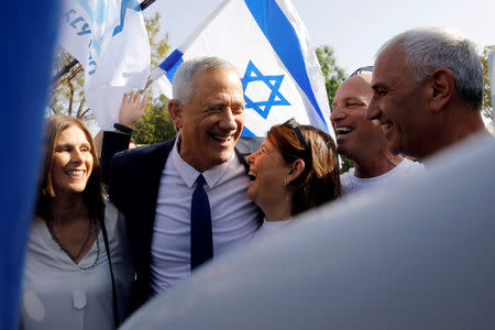 Benny Gantz, leader of Blue and White party, celebrates with supporters and his wife Revital after casting his ballot as Israelis began voting in a parliamentary election, near a polling station in Rosh Ha'ayin, Israel April 9, 2019. REUTERS/Nir Elias