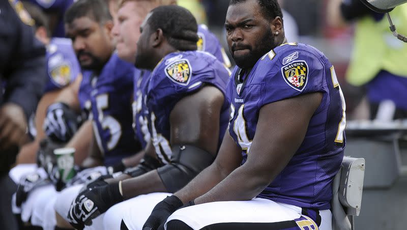 Baltimore Ravens offensive tackle Michael Oher sits on the beach during an NFL game against the Buffalo Bills in Baltimore, Sunday, Oct. 24, 2010. Oher, the former NFL tackle known for the movie “The Blind Side,” filed a petition Monday in a Tennessee probate court accusing Sean and Leigh Anne Tuohy of lying to him by having him sign papers making them his conservators rather than his adoptive parents nearly two decades ago.
