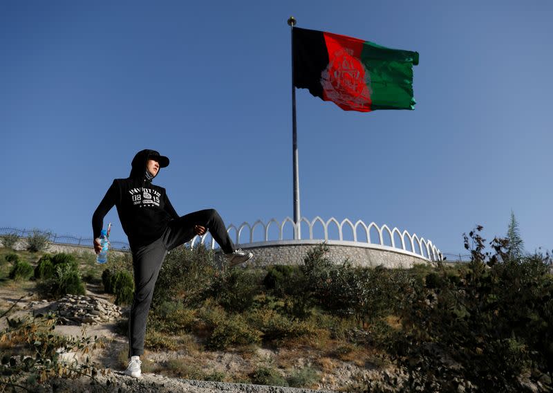 Fatima Sultani, 18 a member of Hikeventures mountaineering team, excercises on a hilltop in Kabul