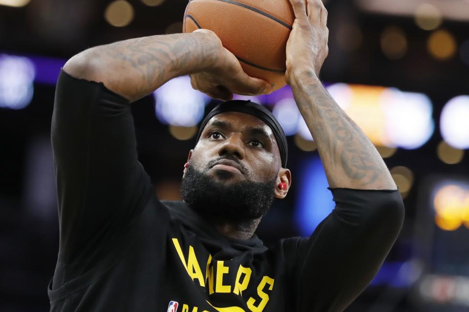 Los Angeles Lakers' LeBron James warms up before an NBA basketball game against the Boston Celtics, Friday, Nov. 19, 2021, in Boston. (AP Photo/Michael Dwyer)