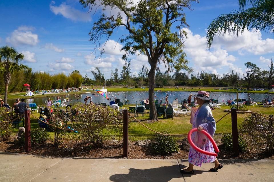 Visitors enjoy Warm Mineral Springs Park on Friday, the first day of its reopening after Hurricane Ian.