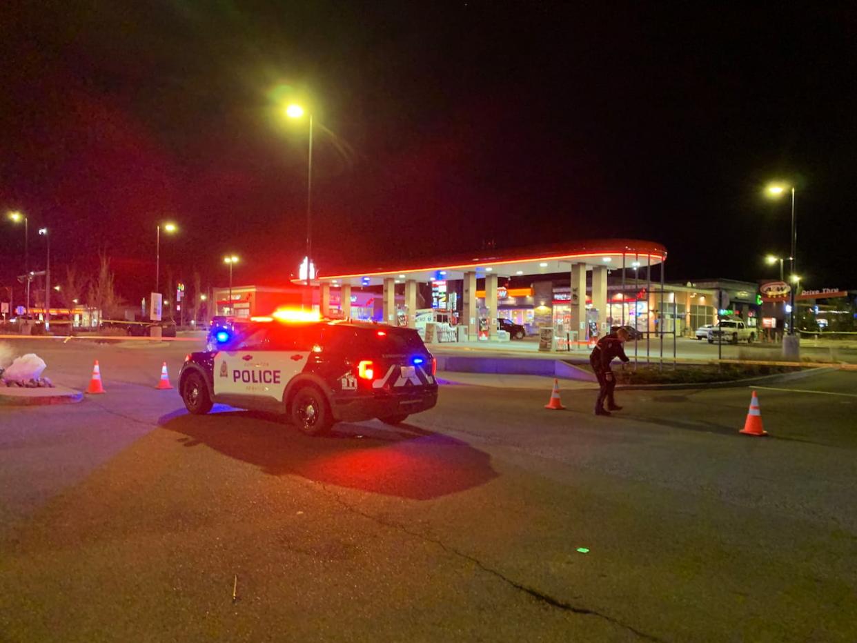 Police are investigating the shooting deaths of a father and son in southeast Edmonton Thursday. Officers remained on scene Thursday night.  (Julia Wong/CBC - image credit)