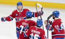Montreal Canadiens' Joshua Roy (89) celebrates his goal against the Columbus Blue Jackets with Arber Xhekaj (72), Alex Newhook (15) and David Savard (58) during the first period of an NHL hockey game Tuesday, March 12, 2024, in Montreal. (Christinne Muschi/The Canadian Press via AP)