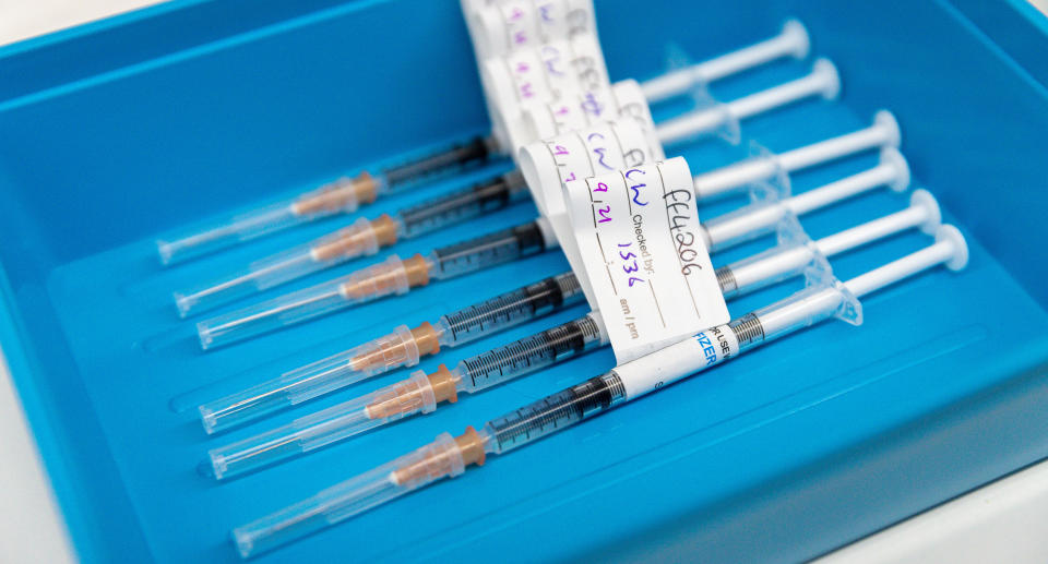 Syringes containing Pfizer vaccine are prepared at a COVID-19 mass vaccination clinic in Midland, an eastern suburb of Perth, Thursday, September 9, 2021. Source: AAP