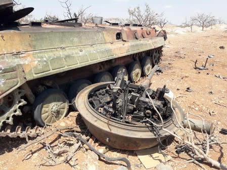 A damaged military tank is seen in Idlib countryside