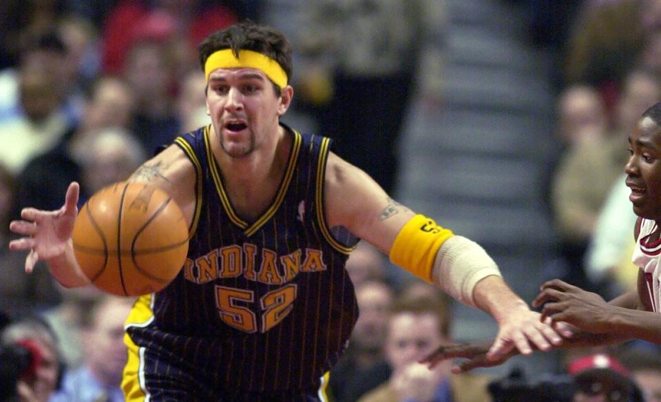 FILE -- Indiana Pacers' Brad Miller (55) tries for a loose ball as Chicago Bulls' Jamal Crawford right watches during the first quarter Saturday Dec. 21 2002 in Chicago.