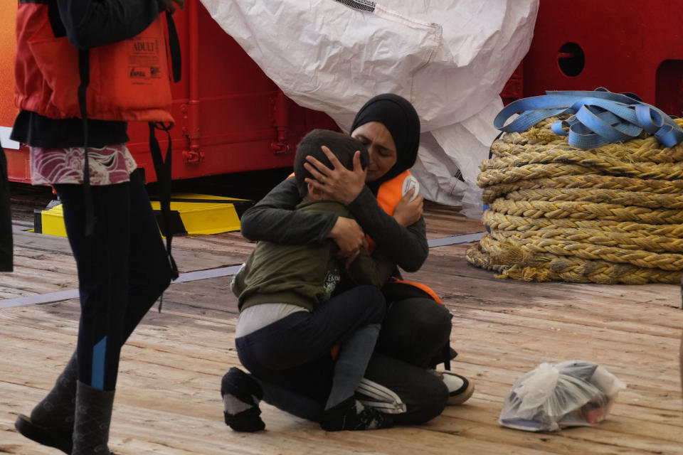 A Syrian woman hugs her child after being rescued by the Spanish NGO Open Arms lifeguards during an operation in the international waters zone near Tunisia, Mediterranean sea, Saturday, Sept. 17, 2022. Fifty-nine migrants from Syria, Egypt, Sudan and Eritrea, 10 of them minors, were rescued by NGO Open Arms crew members. (AP Photo/Petros Karadjias)